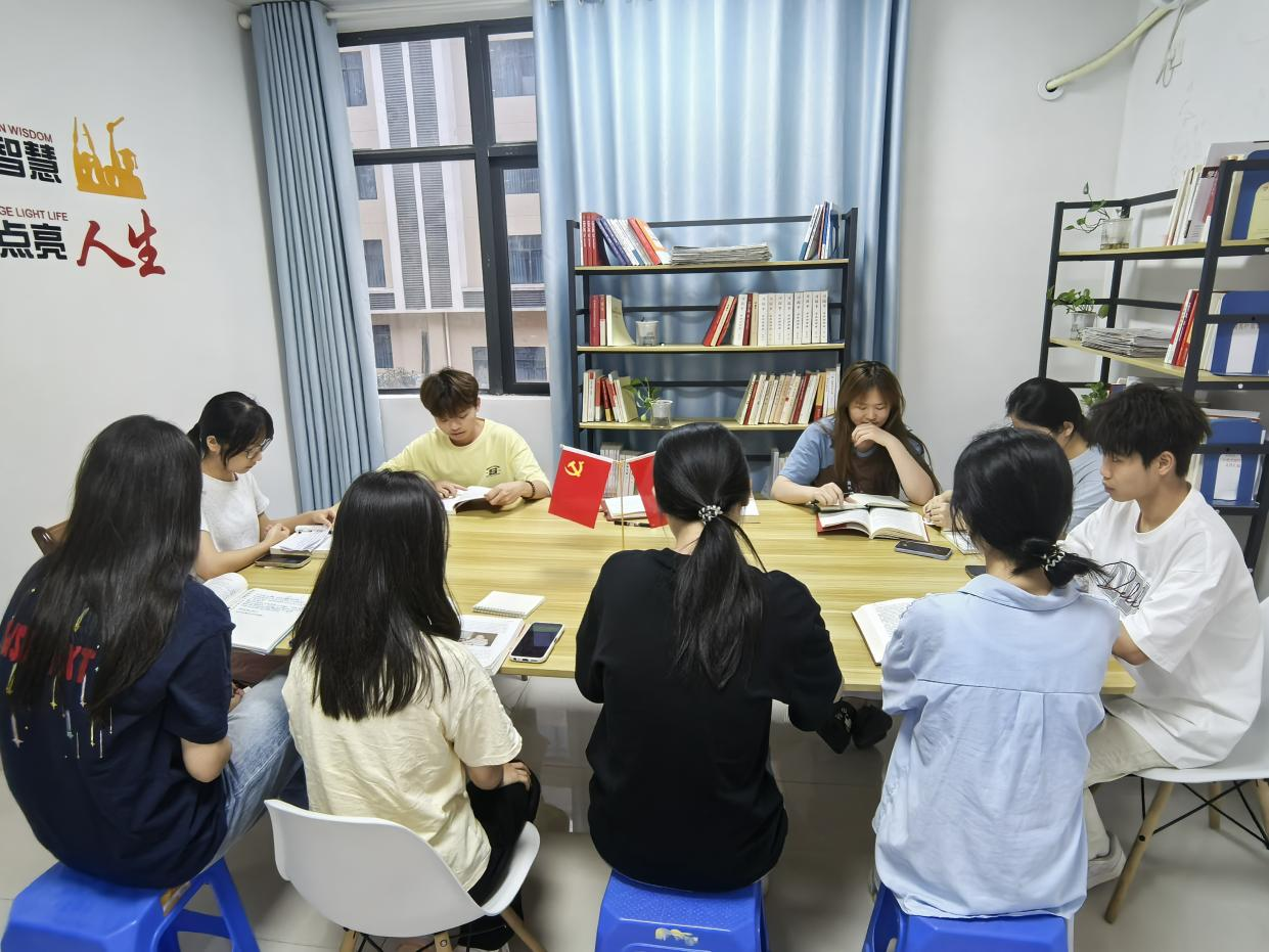 图为入党积极分子认真阅读红色书籍