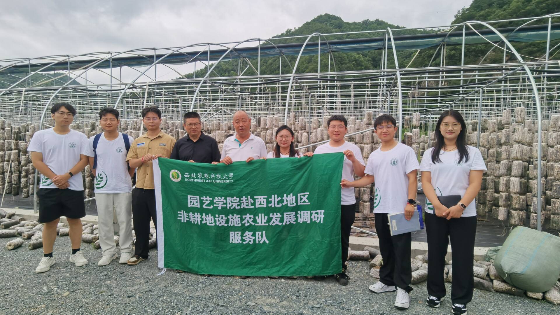 图为调研队成员与访谈人员在木耳生产一线的合影。于超奇 供图