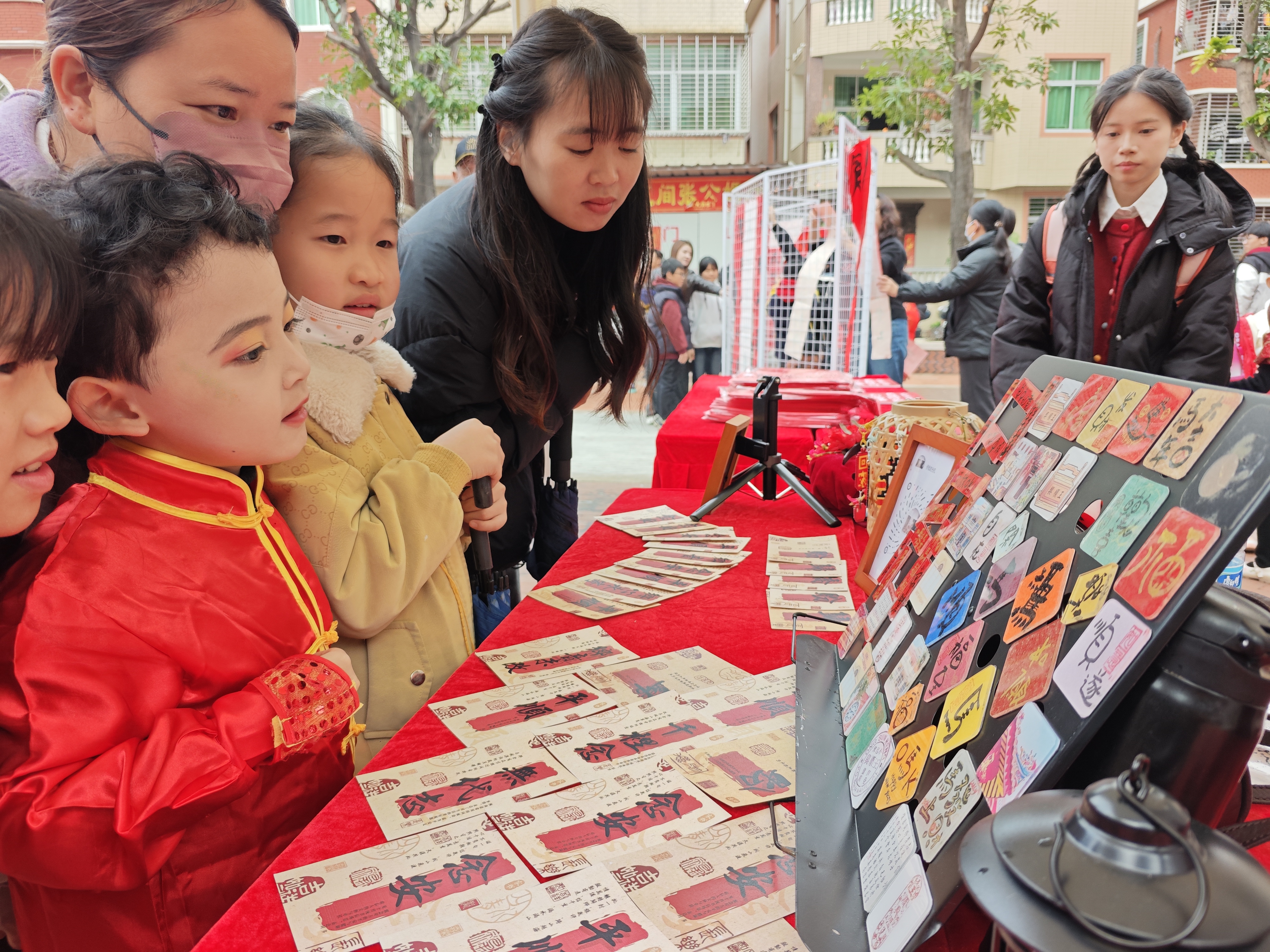 图为实践队侨文创产品在“龙腾鲤跃 福满王宫”新春喜乐会上与现场观众互动